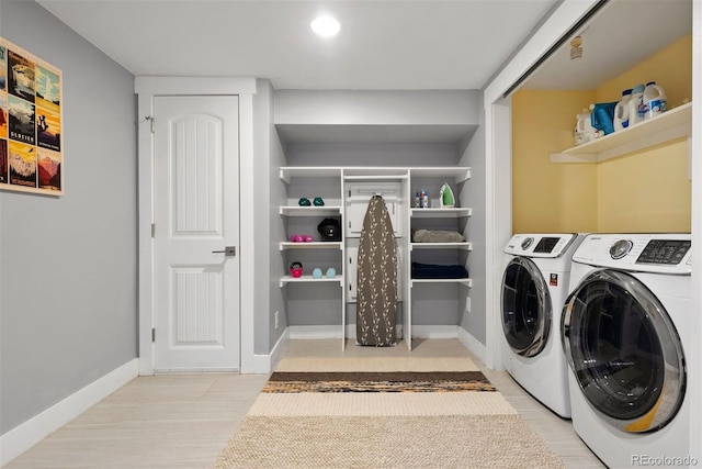 laundry room featuring laundry area, baseboards, and washer and dryer