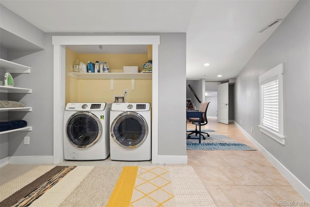 washroom featuring laundry area, baseboards, visible vents, and washer and dryer