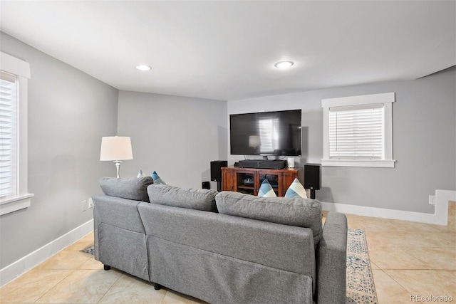 living room featuring recessed lighting, light tile patterned flooring, and baseboards