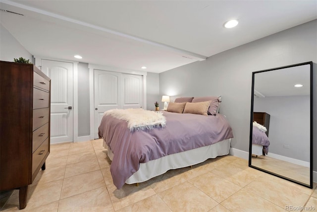 bedroom featuring baseboards, light tile patterned flooring, and recessed lighting