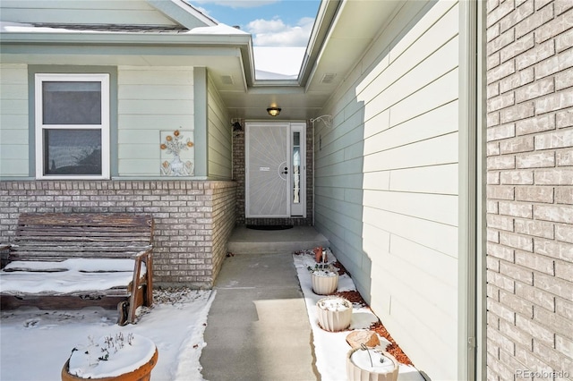 view of snow covered property entrance