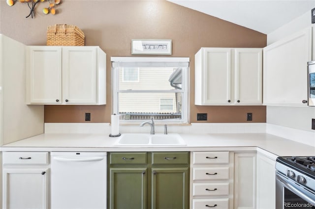 kitchen featuring lofted ceiling, sink, stainless steel appliances, and white cabinets