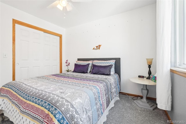 carpeted bedroom featuring ceiling fan and a closet