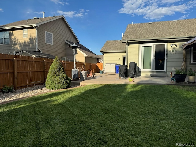 rear view of house with a yard and a patio area