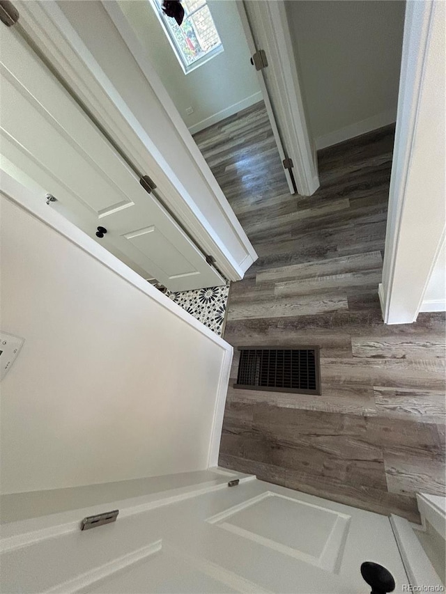 stairway with hardwood / wood-style floors