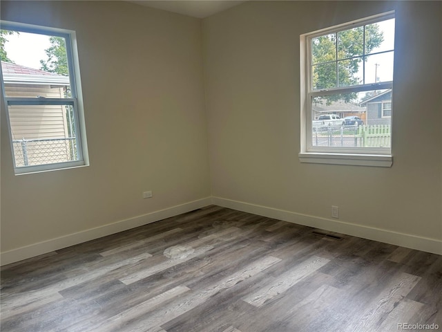 unfurnished room with hardwood / wood-style floors