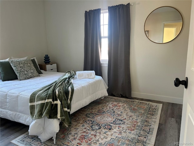 bedroom with dark wood-type flooring