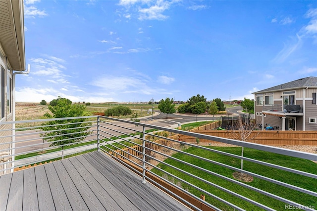 wooden terrace with a lawn