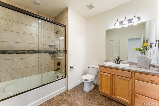 full bathroom with enclosed tub / shower combo, toilet, vanity, and tile patterned flooring