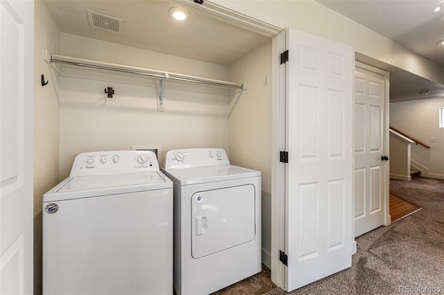 clothes washing area featuring dark colored carpet and independent washer and dryer