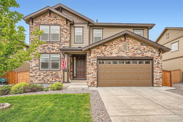 25128 E Maple Ave, Aurora, CO 80018 - view of front of house with stone siding, concrete driveway, and an attached garage