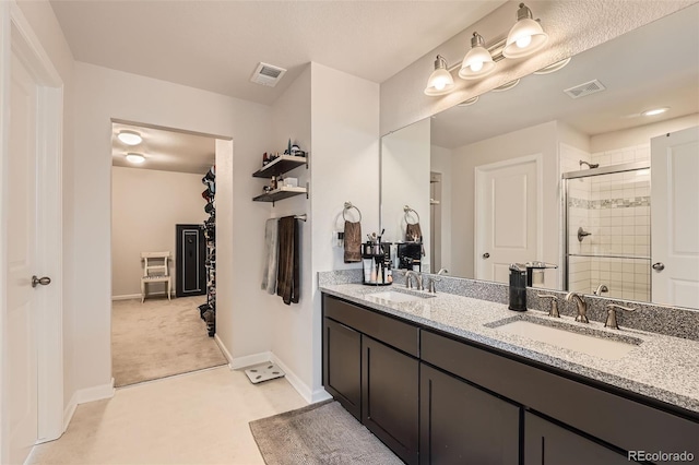25128 E Maple Ave, Aurora, CO 80018 - bathroom with a shower stall, double vanity, and baseboards