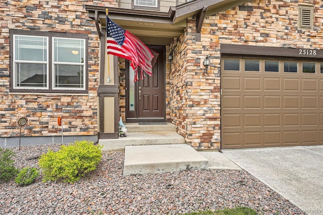 25128 E Maple Ave, Aurora, CO 80018 - property entrance featuring stone siding and an attached garage