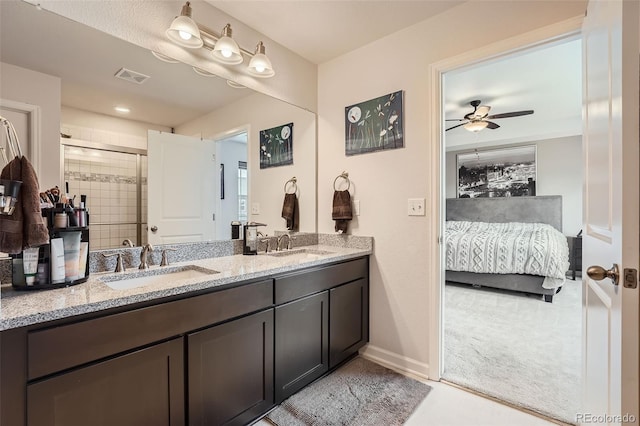 25128 E Maple Ave, Aurora, CO 80018 - ensuite bathroom with double vanity, a ceiling fan, a tile shower, and baseboards