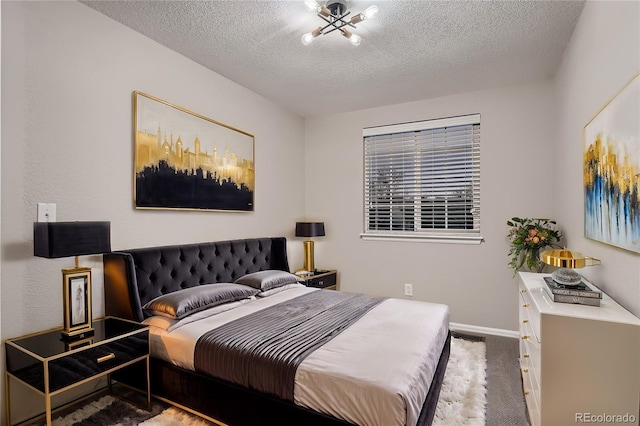 bedroom featuring carpet floors and a textured ceiling