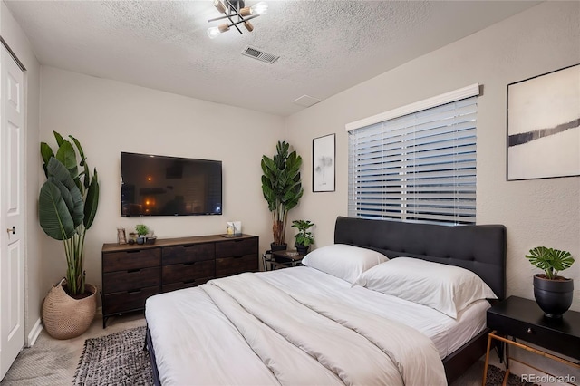 carpeted bedroom with a textured ceiling