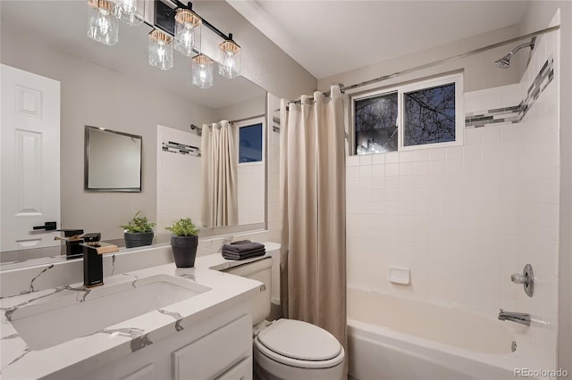 full bathroom featuring toilet, vanity, and shower / bathtub combination with curtain