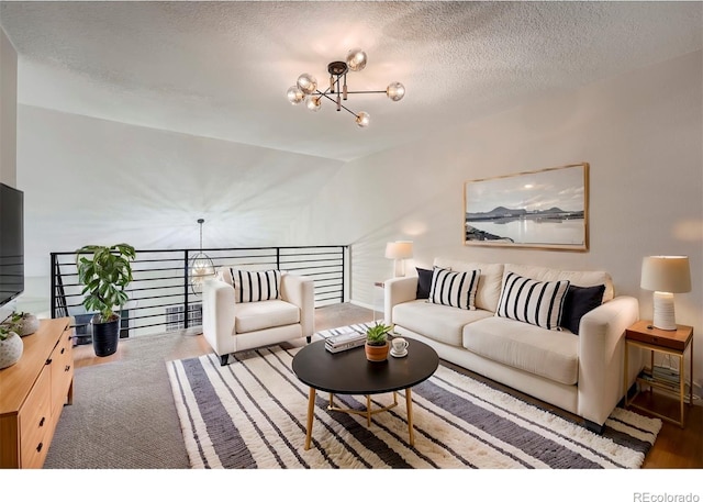 living room with lofted ceiling, a textured ceiling, and a chandelier