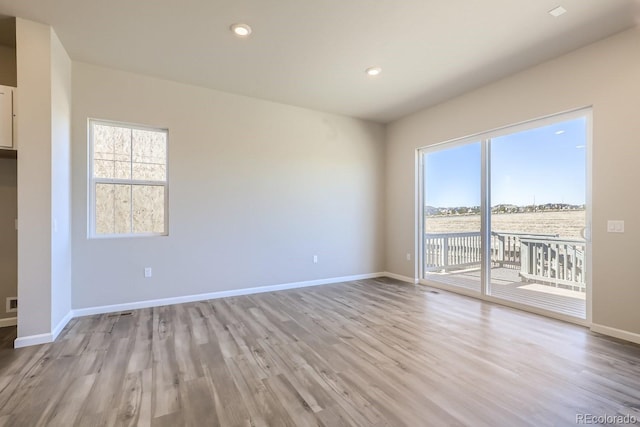 spare room featuring light wood-type flooring