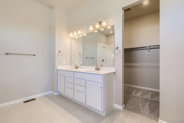 bathroom with tile patterned flooring and vanity