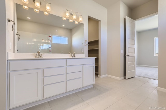 bathroom featuring tile patterned floors, vanity, and walk in shower