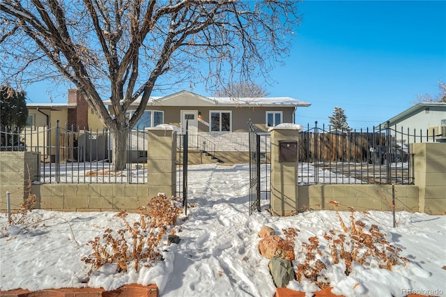 view of front of property featuring a fenced front yard, a gate, and stucco siding