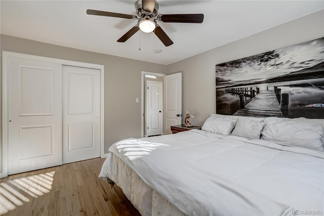 bedroom with a closet, ceiling fan, and light wood finished floors