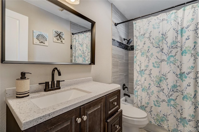 full bath with shower / bath combo, vanity, and toilet