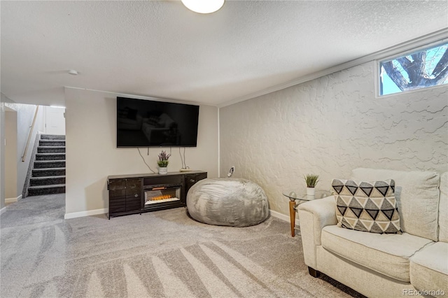 carpeted living room featuring baseboards, a textured wall, stairway, and a textured ceiling