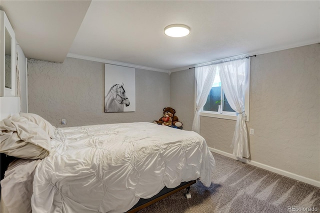 carpeted bedroom featuring a textured wall, ornamental molding, and baseboards