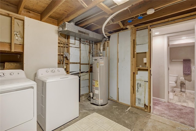 washroom with laundry area, water heater, and washer and dryer