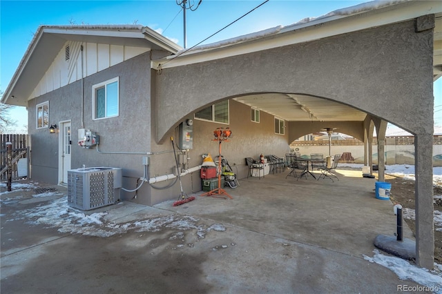 back of property featuring stucco siding, a patio area, fence, and central AC unit