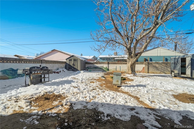 exterior space with an outbuilding, a fenced backyard, and a storage shed