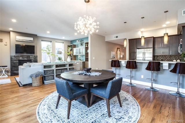 dining room with an inviting chandelier and light hardwood / wood-style floors