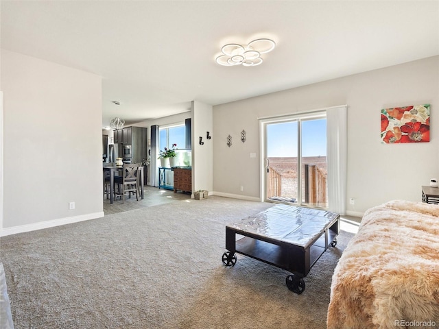 carpeted living area featuring baseboards and a healthy amount of sunlight