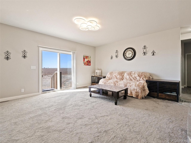 living area featuring carpet and baseboards