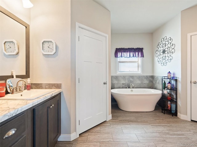 bathroom with a freestanding bath and vanity