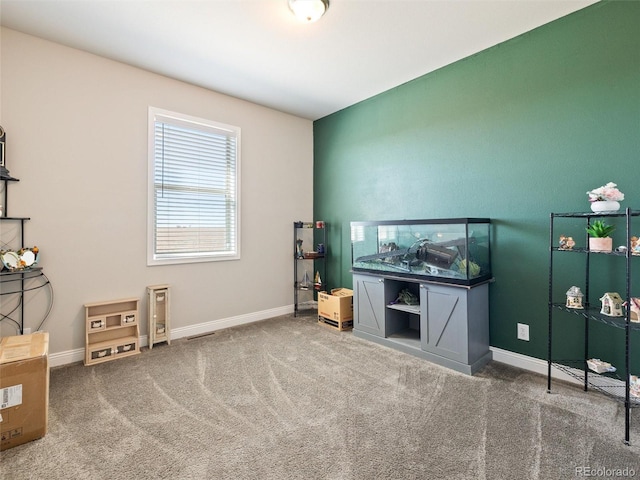 misc room with carpet and baseboards