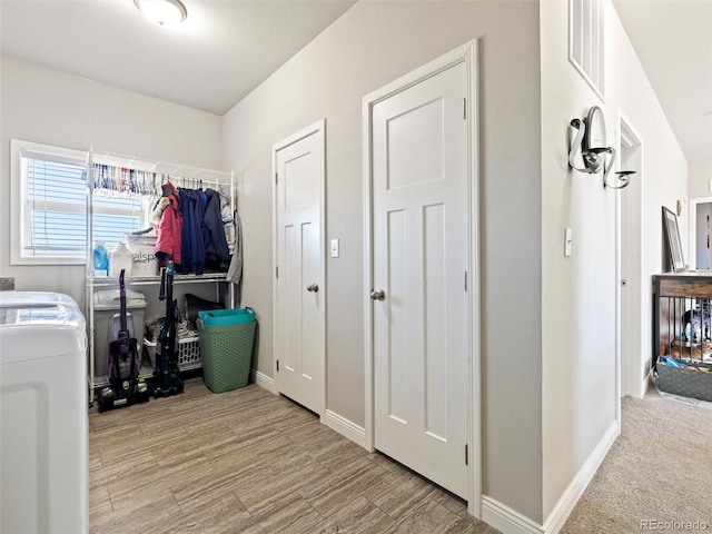 washroom with laundry area, visible vents, baseboards, light wood-type flooring, and washer / dryer