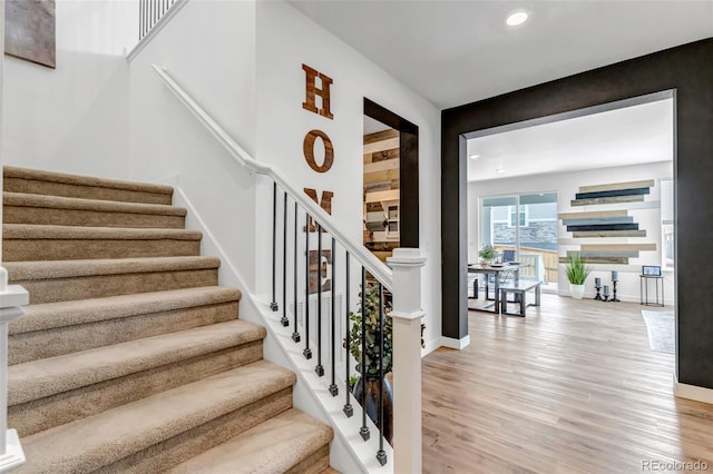 stairs featuring recessed lighting, baseboards, and wood finished floors