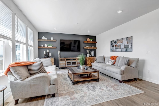 living room with baseboards, recessed lighting, and wood finished floors