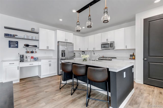 kitchen with light countertops, appliances with stainless steel finishes, and white cabinets