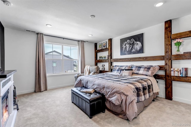 bedroom with light colored carpet, baseboards, and visible vents