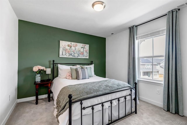 bedroom with baseboards, light carpet, and visible vents