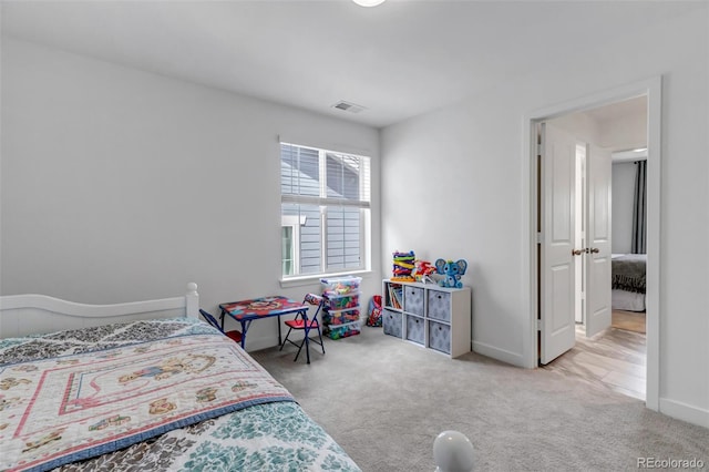 carpeted bedroom with baseboards and visible vents