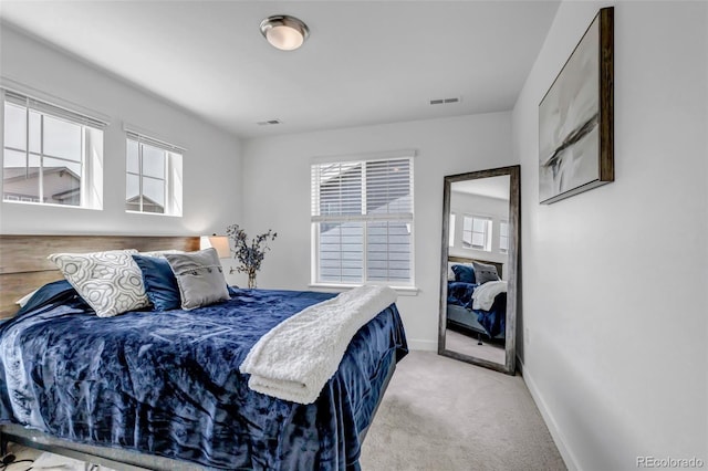 bedroom featuring baseboards, carpet flooring, and visible vents