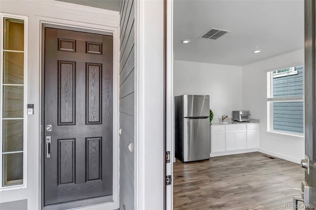 property entrance with visible vents and a sink