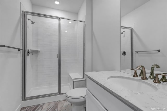 full bath featuring a shower stall, vanity, toilet, marble finish floor, and recessed lighting