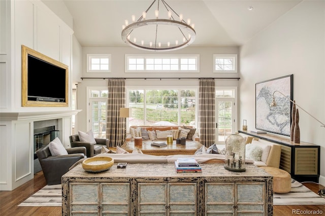 5425 S University Blvd, Greenwood Village, CO 80121 - living room featuring a chandelier, wood finished floors, high vaulted ceiling, and a fireplace