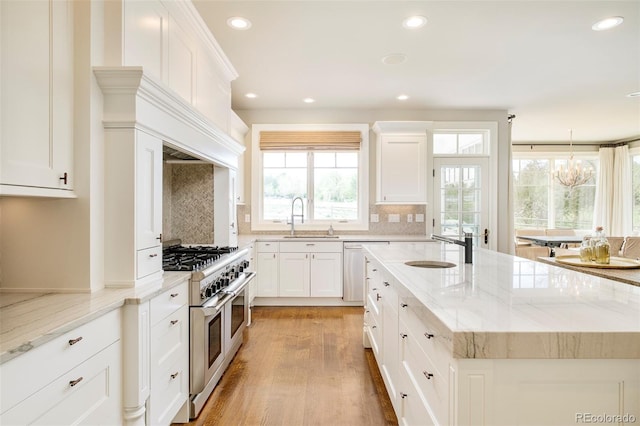 5425 S University Blvd, Greenwood Village, CO 80121 - kitchen with stainless steel appliances, a sink, a center island with sink, recessed lighting, and decorative backsplash